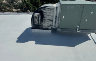 A rooftop HVAC unit with black streaks and wear on a flat roof, highlighting the need for exterior restoration in Colorado Springs.